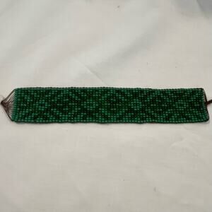 Green beaded bracelet with design